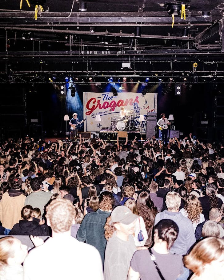 A massive crowd enjoys The Grogans on stage.