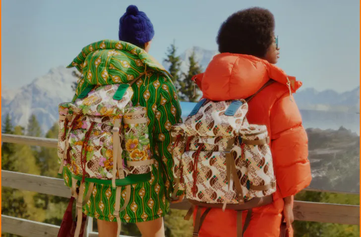 Two people with The North Face x Gucci backpacks on. 