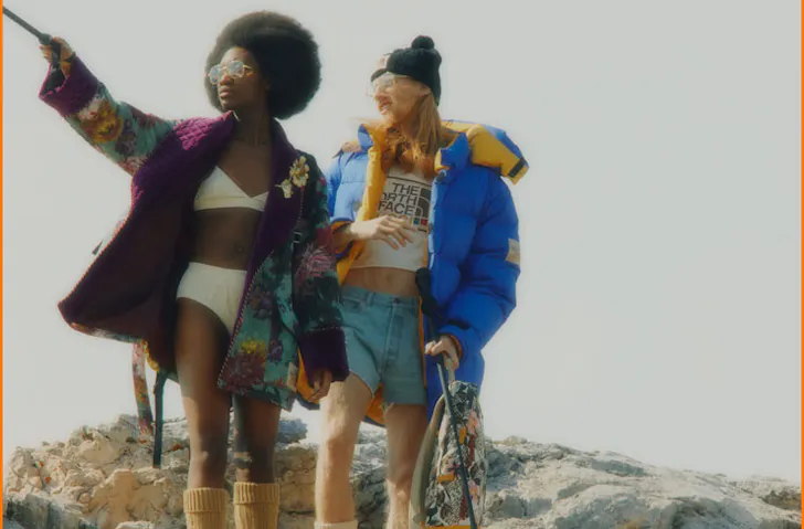 Two models wearing The North Face x Gucci. 