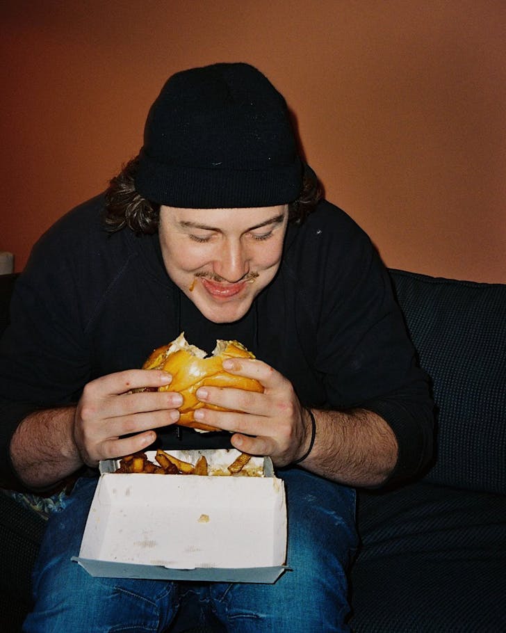 Guy eating a burger.