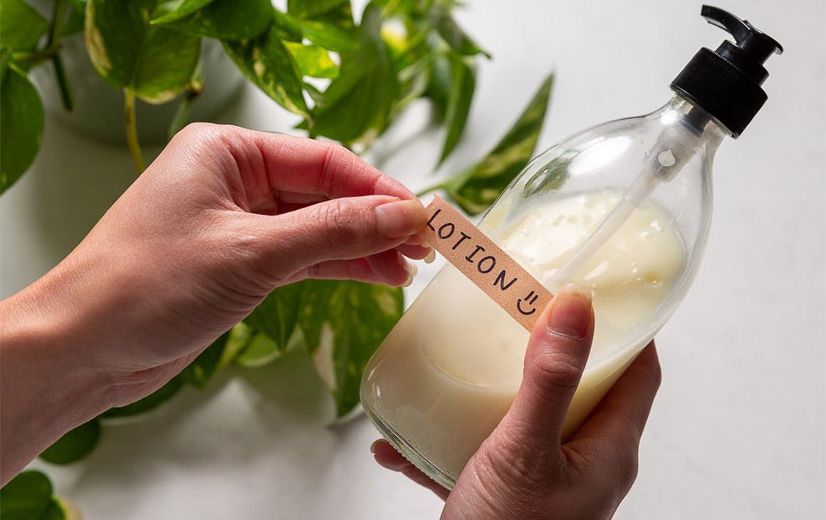 hands holding a bottle of lotion