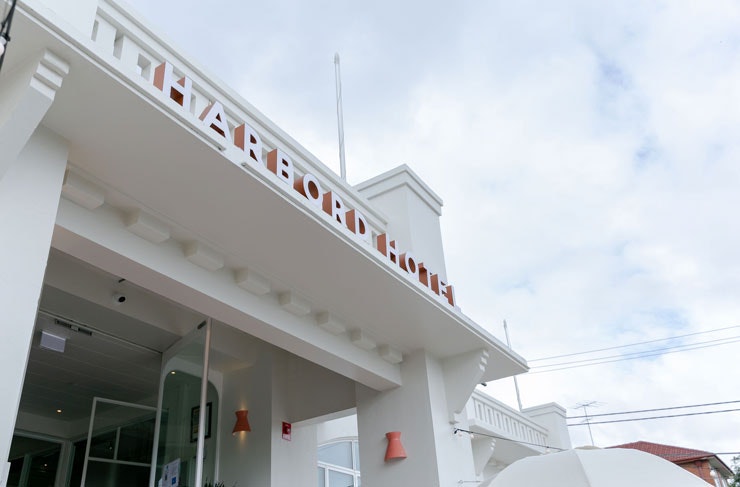 The white facade and signage of the Harbord Hotel. 