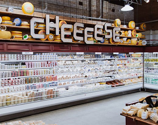 a grocery fridge full of cheese