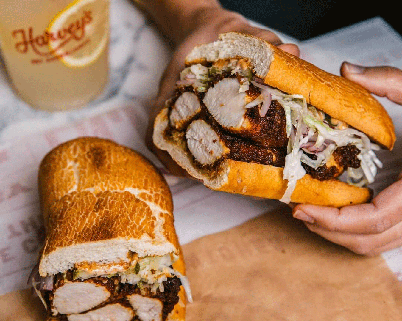 Hand holding sandwich roll