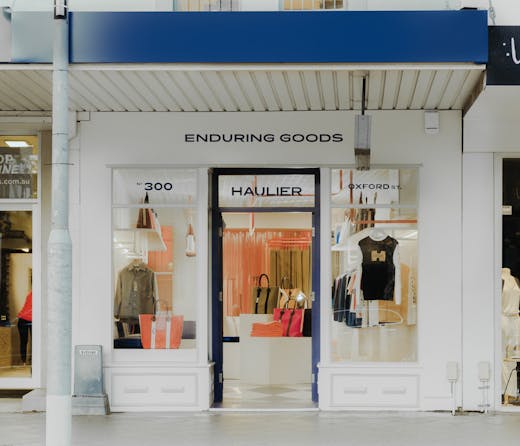 A white shop front outside a fashion boutique. 