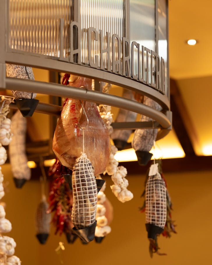 jamon, chillis and garlic hang from a deli at hay st market in sydney