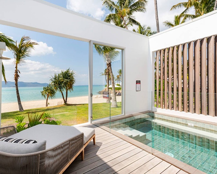 A pool and deck overlooking the ocean at InterContinental Hayman Great Barrier Reef one of the best romantic getaways Queensland