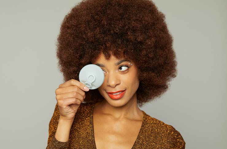 A woman holding a Hello Disc