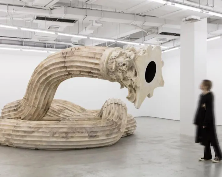 A robotic sculpture appears to stare at a gallery attendee. 
