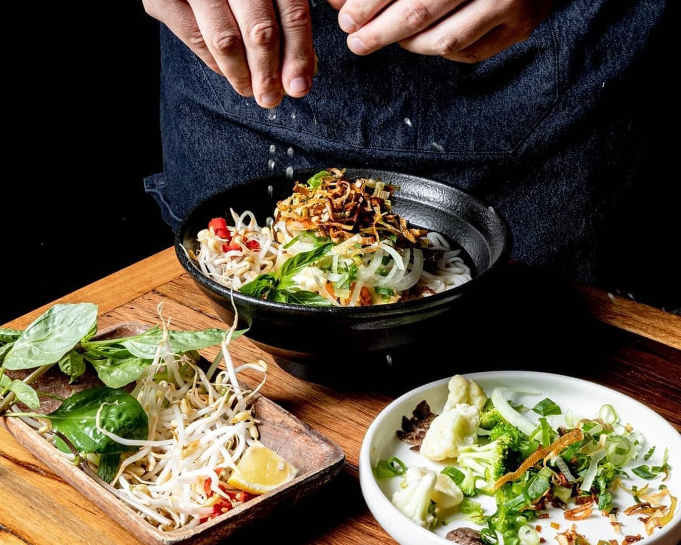 pho and other Vietnamese dishes on table