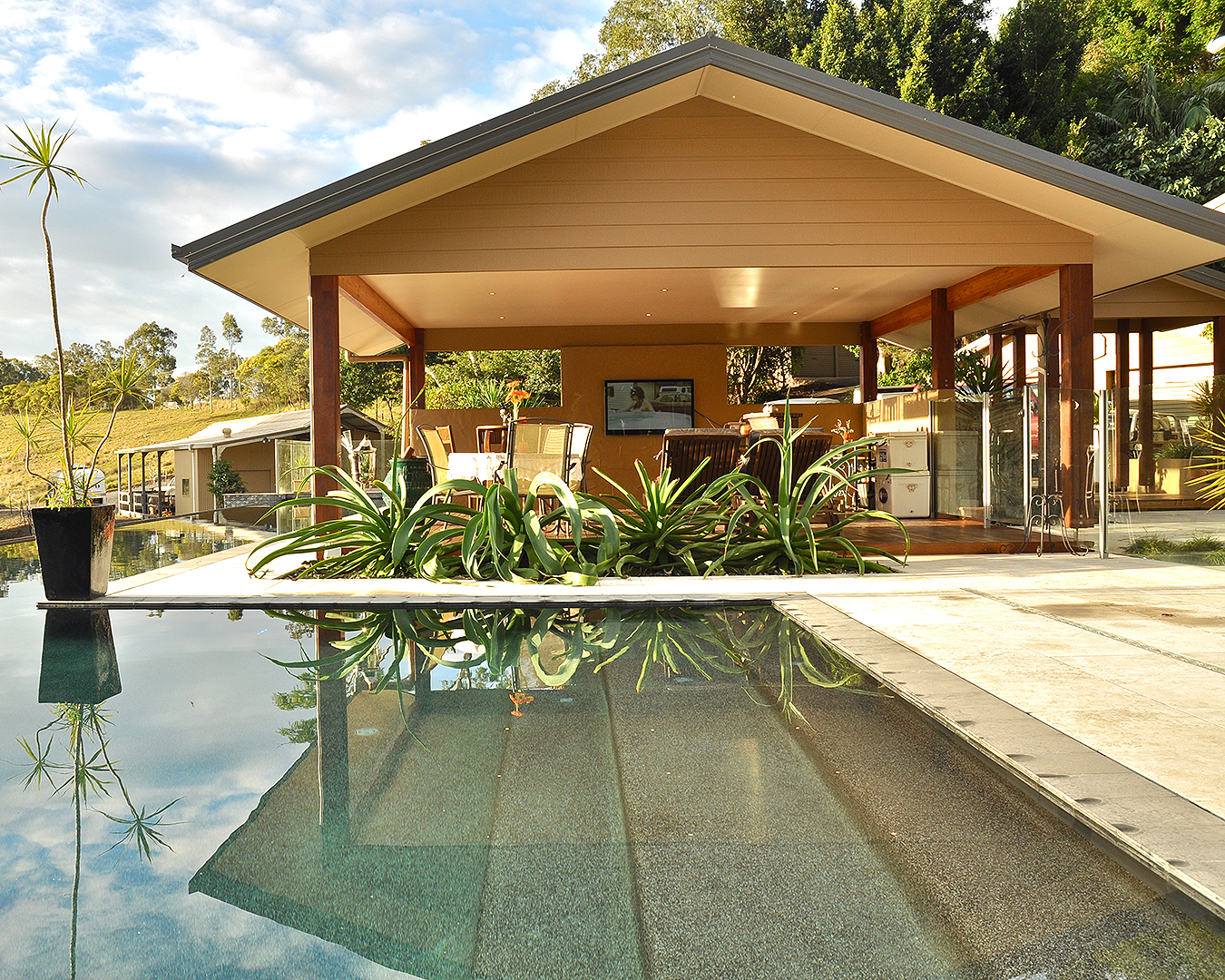 A house looking out onto an inviting pool.