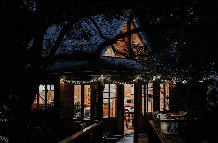 a dark and cosy cabin in the rainforest.