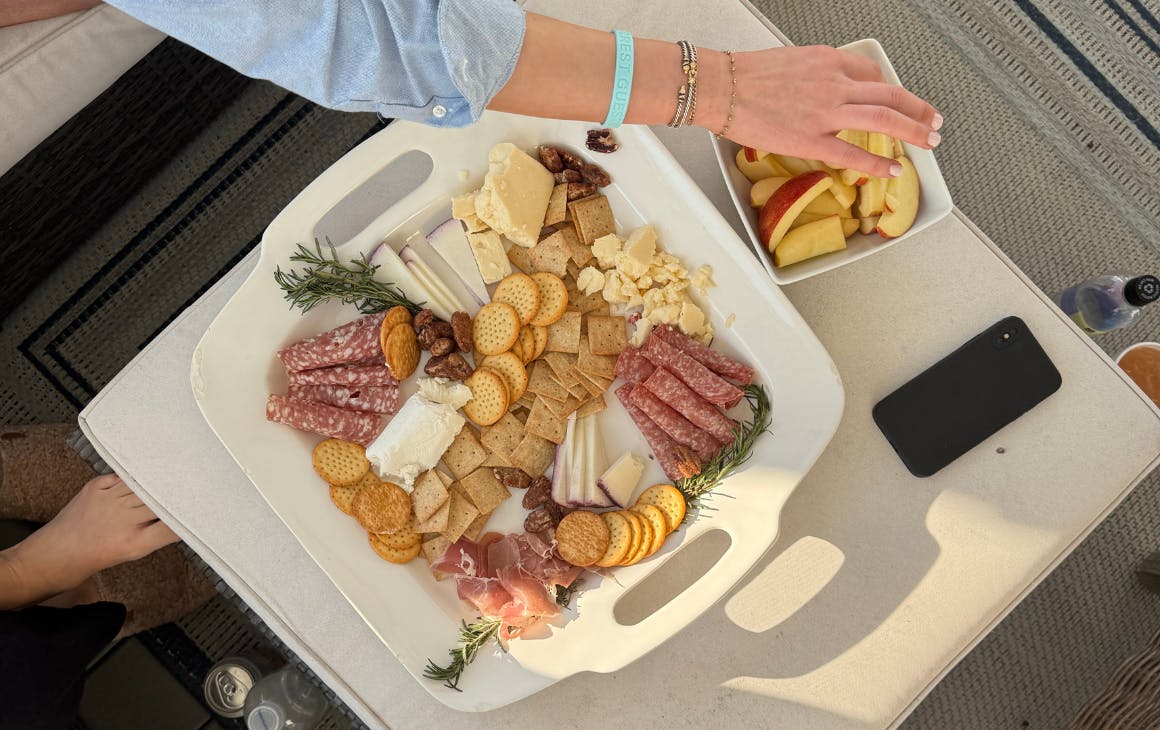 Hand grabbing over a cheeseboard