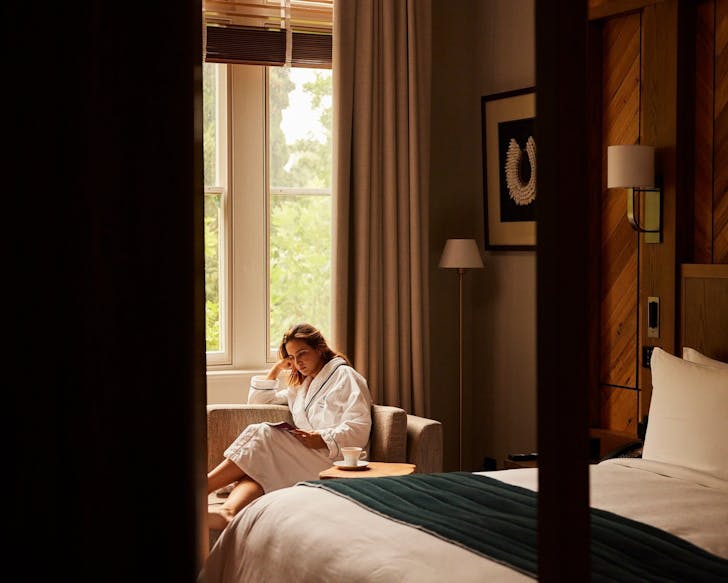 A guest inside a heritage room at The Tasman Hotel in Hobart