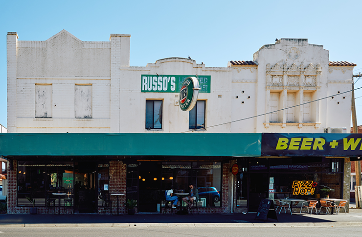 An old-style street grocer building with a green roof sign, one of the most unique pubs and one of the best pubs in Melbourne.