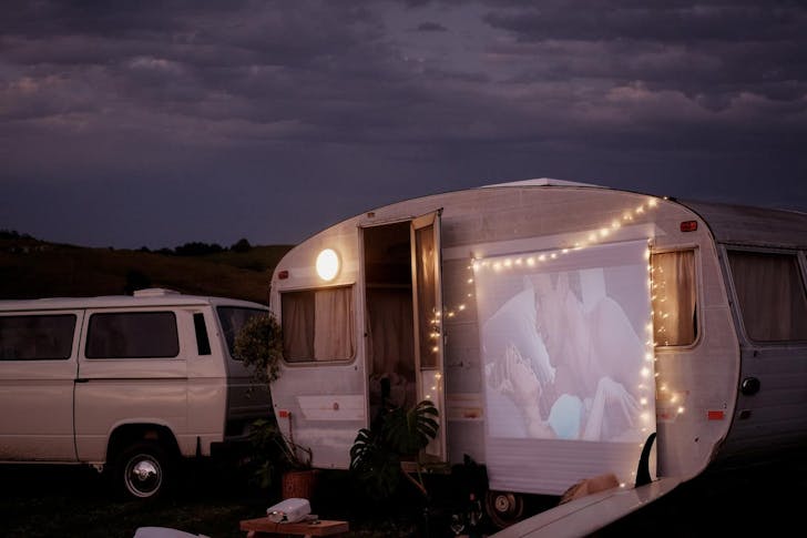 a caravan with a movie screen on the side