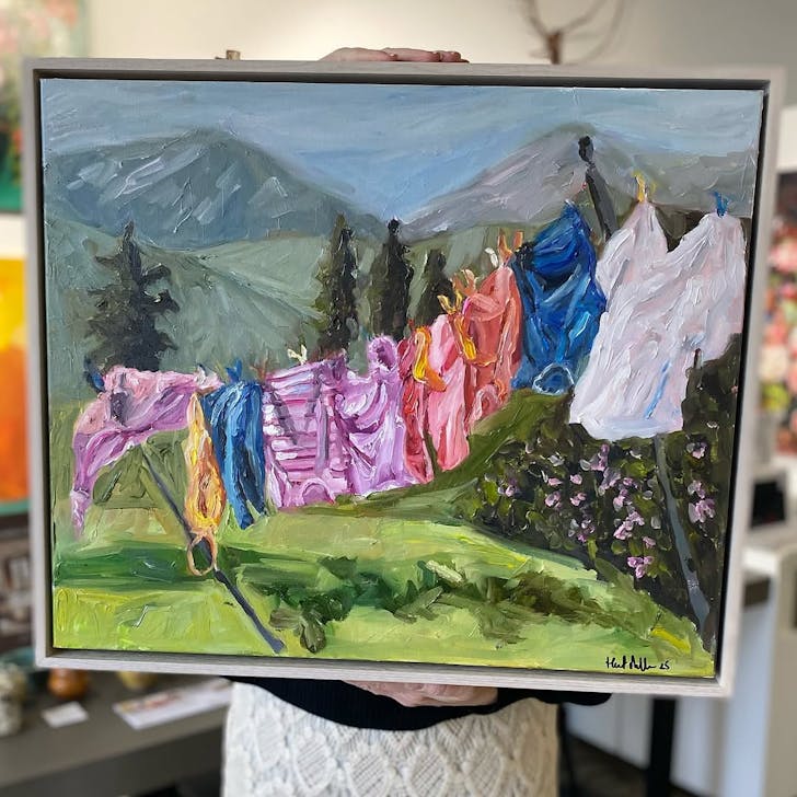 Harriet Miller's colourful impressionist painting 'Washing Day' depicts colourful washing hung out in front of a distant mountain range.