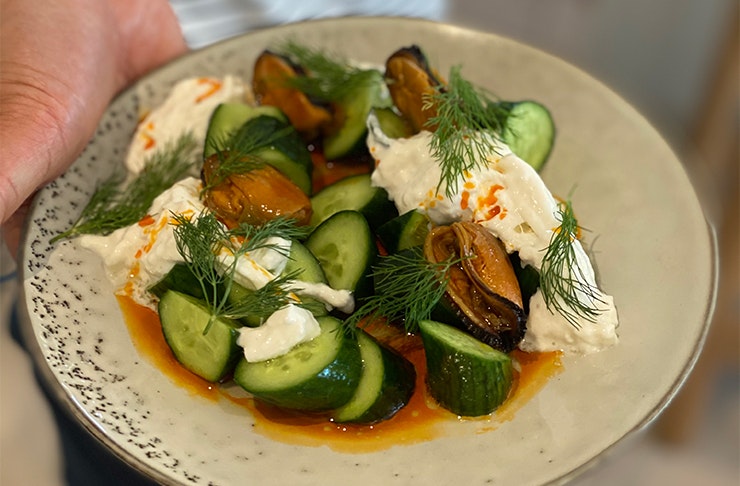 a close-up shot of a cucumber and white cheese dish