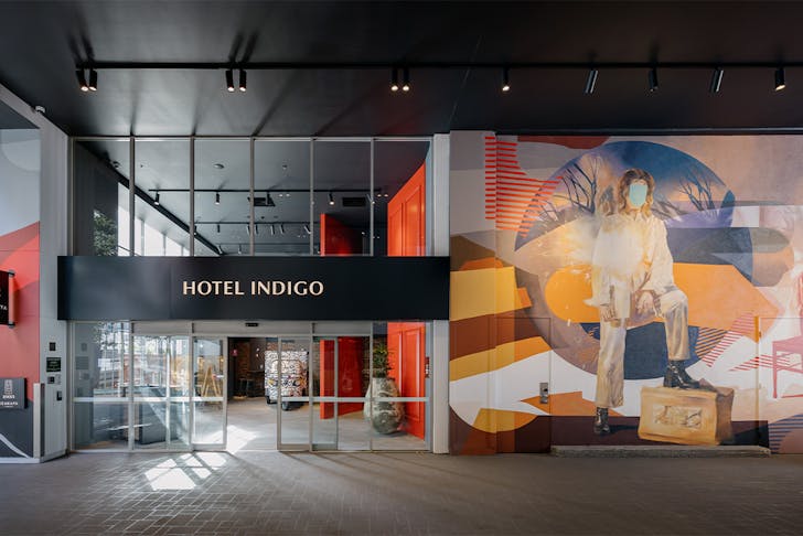 exterior facade of hotel indigo with a mural