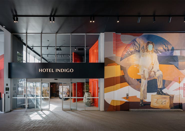 exterior facade of hotel indigo with a mural