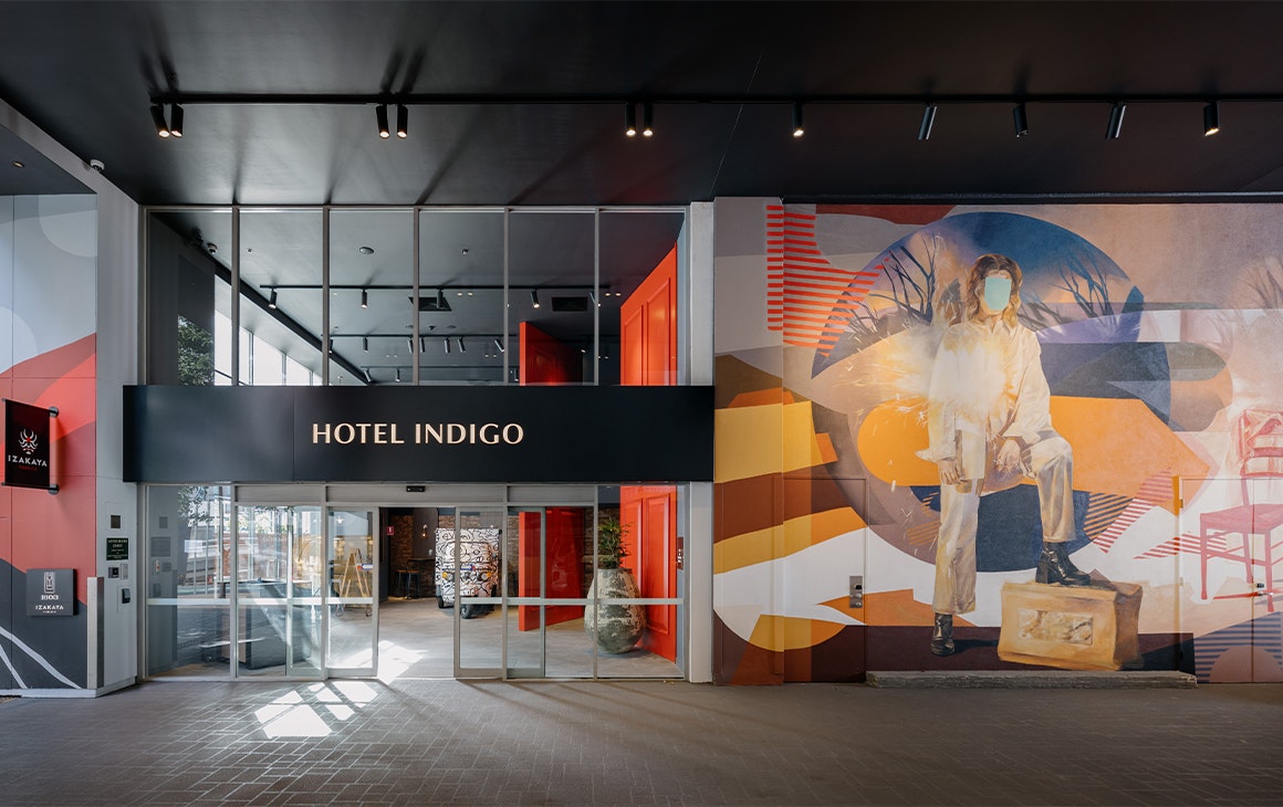 exterior facade of hotel indigo with a mural