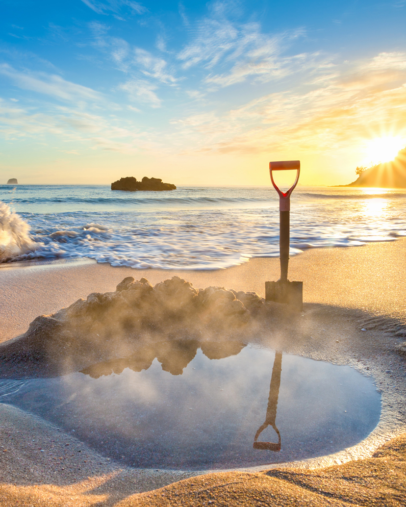 A spade dug in the sand at Hot Water Beach in The Coromandel.