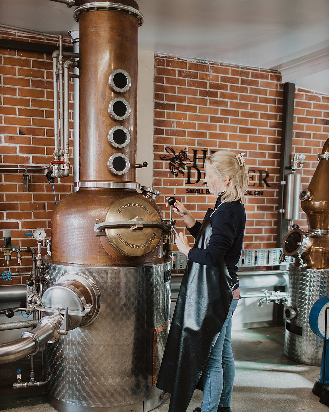 Someone makes gin at a distillery.