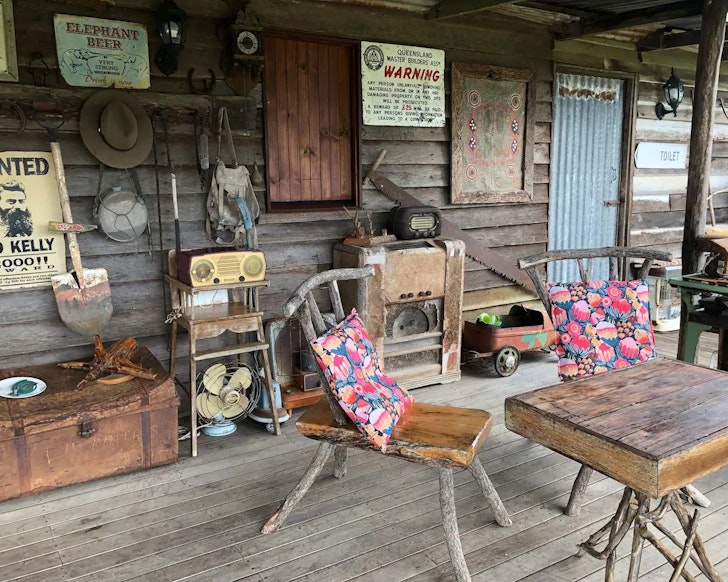 Rustic chairs on the deck at Rangeview Outback Hut one of the best farm stays near Brisbane