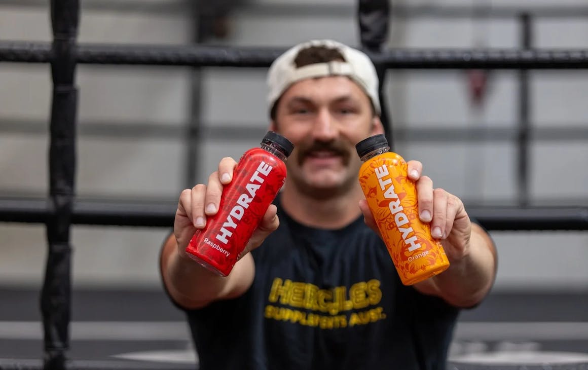 Someone holding up two bottles of Hydrate