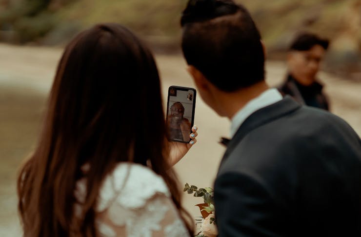 A couple getting married with a family member on Facetime.