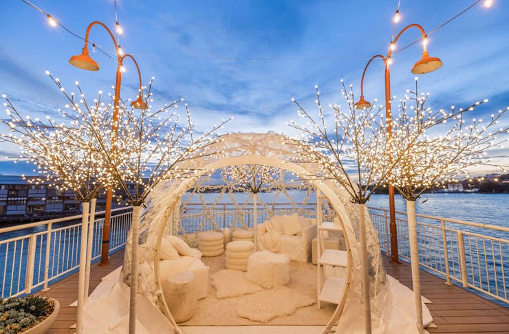 The pop-up igloo suite at Pier One hotel in Sydney, with Walsh Bay and the sunset in the background. 