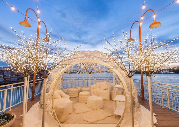 The pop-up igloo suite at Pier One hotel in Sydney, with Walsh Bay and the sunset in the background. 