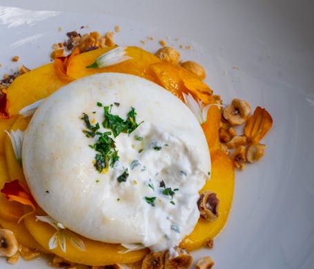 Burrata with peaches and hazelnuts. 