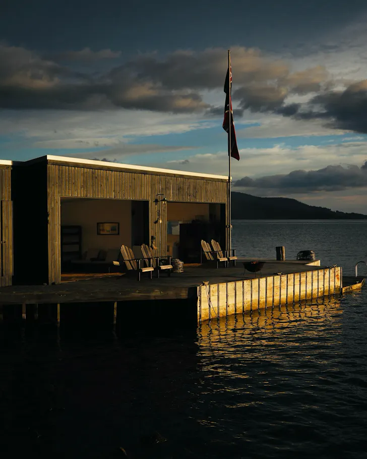 A waterfront shack with a wooden deck