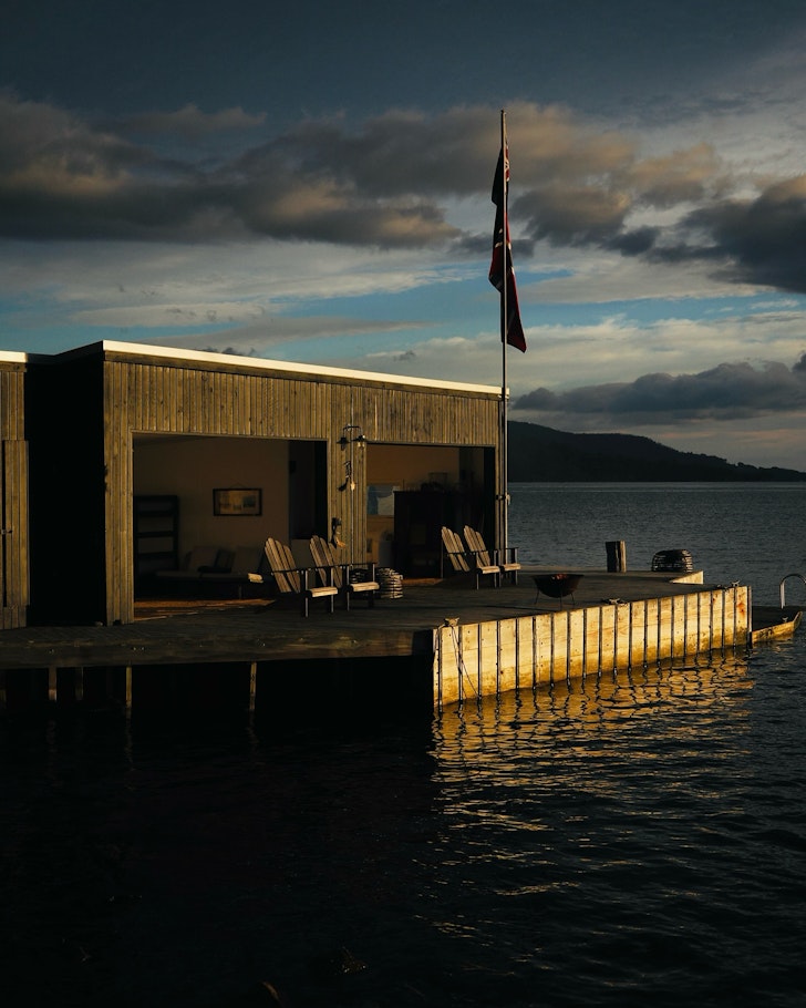A waterfront shack with a wooden deck