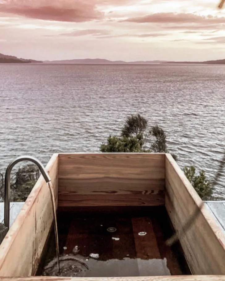 An outdoor wooden bath overlooking the sea