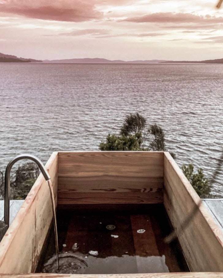 An outdoor wooden bath overlooking the sea