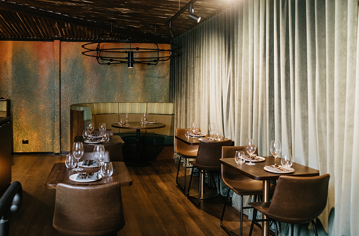 A charming dining room with linen curtains and natural wooden floors.