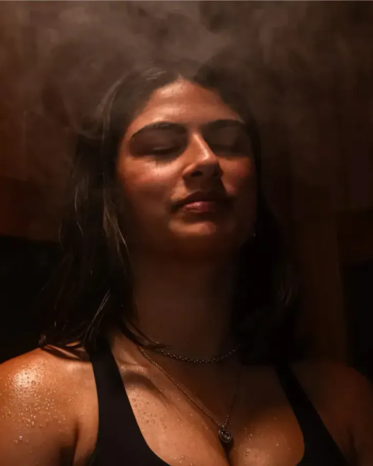 A woman breaks a sweat in an infrared sauna at Chill Wellness.