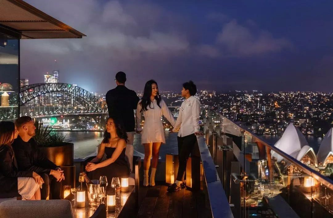 Friends on the balcony at Aster Bar at the InterContinental Sydney