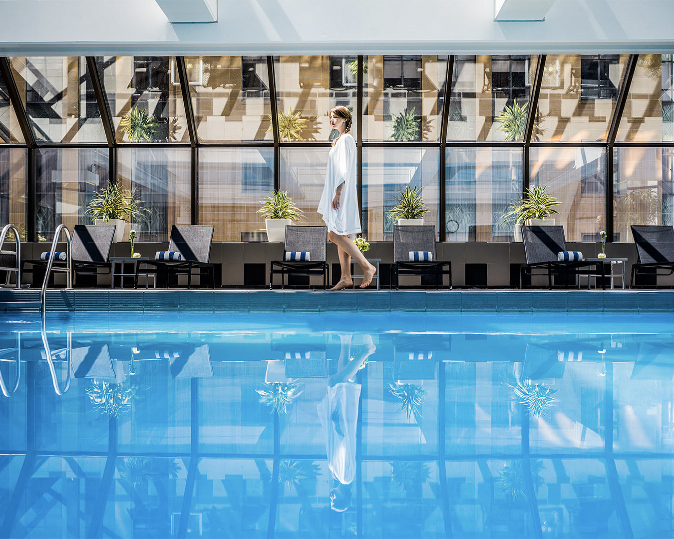 A woman walks by the large pool at the Intercontinental Hotel in Wellington, one of the best luxury hotels in New Zealand.