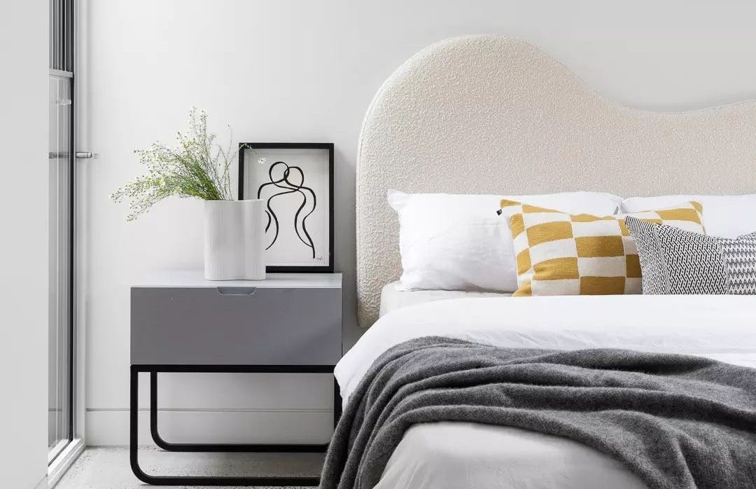 A bed and bedside table