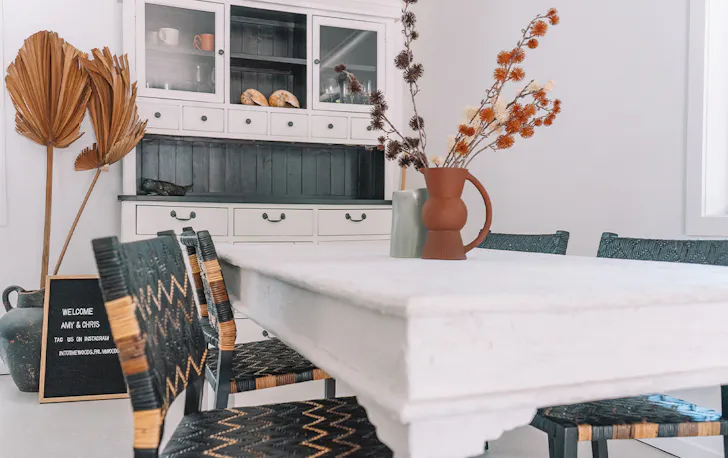a stylish dining table and kitchen cabinet