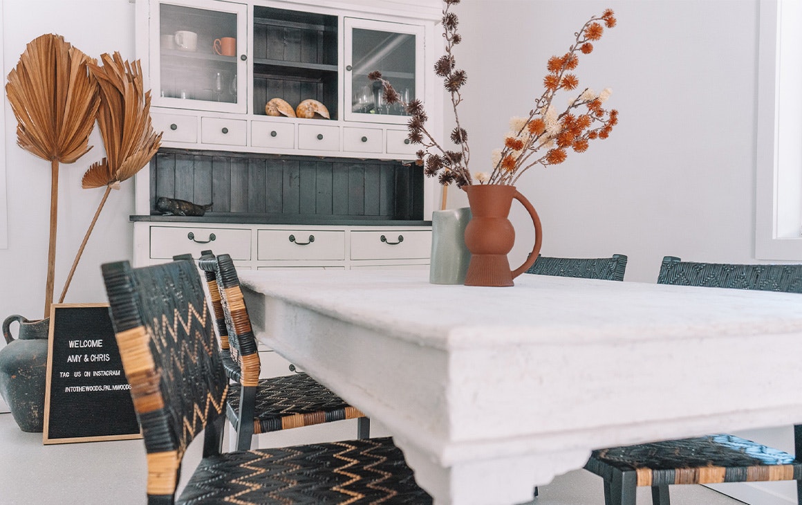a stylish dining table and kitchen cabinet