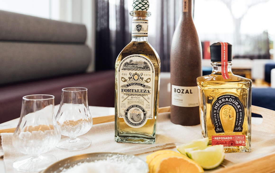 tequila bottles with limes and salt