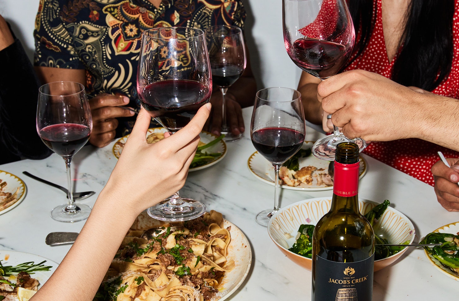 A group of people toasting with wine at a dinner. 