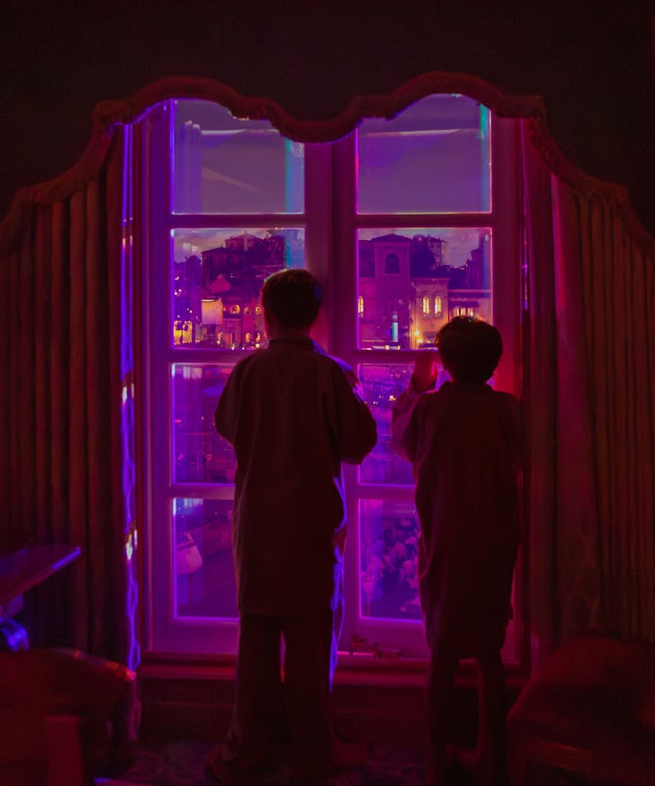 Kids looking out window.