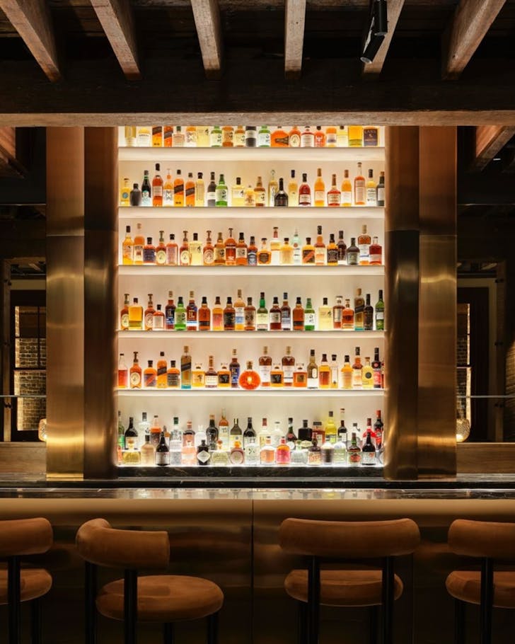 a bar with illuminated bottles of spirits