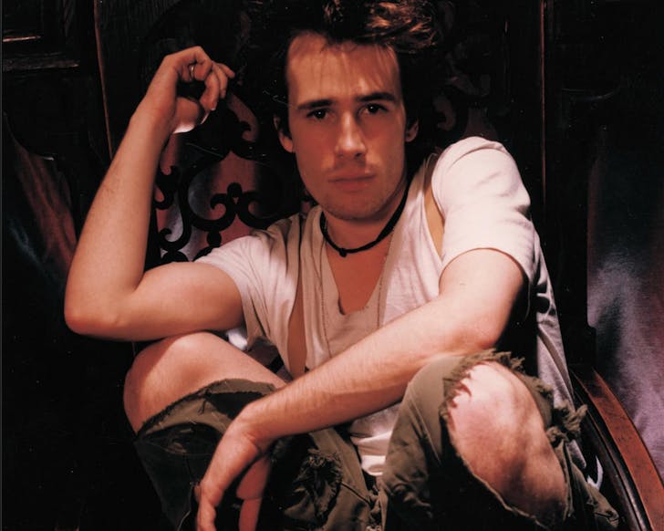 Jeff Buckley poses in a crouch.