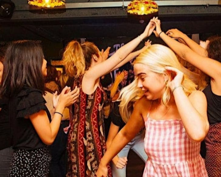 An energetic crowd enjoy a jig.